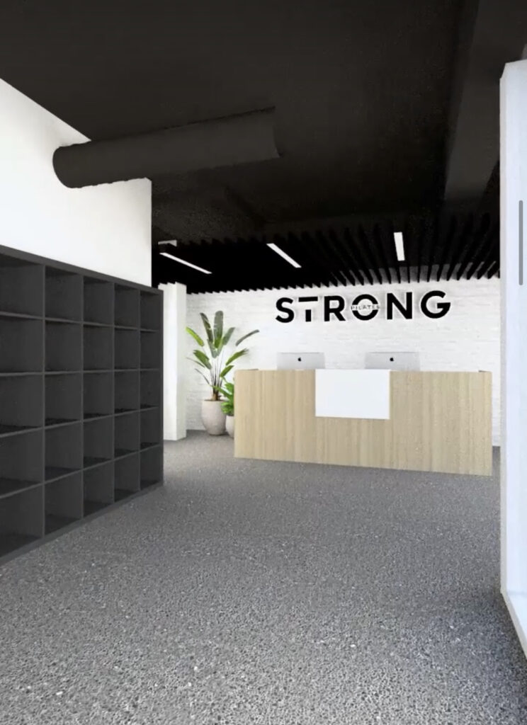 Pilates reformers, black and timber colour palette and welcoming reception area for this fitness fit out for Strong Pilates