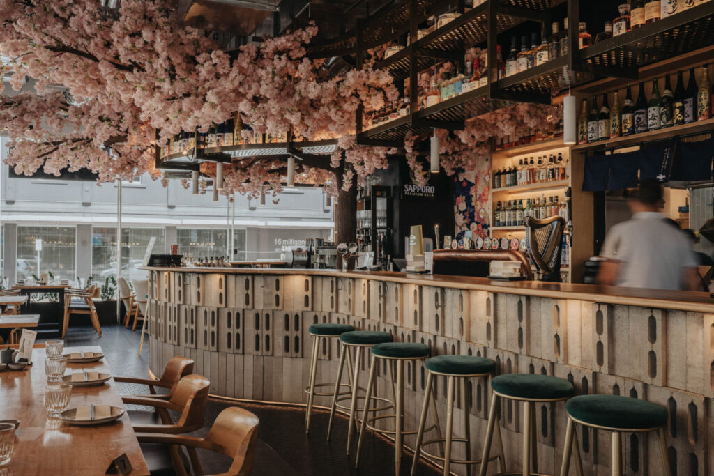 Custom cherry blossom tree feature, bespoke timber flooring and welcoming dining area for this hospitality fit out for Nippon