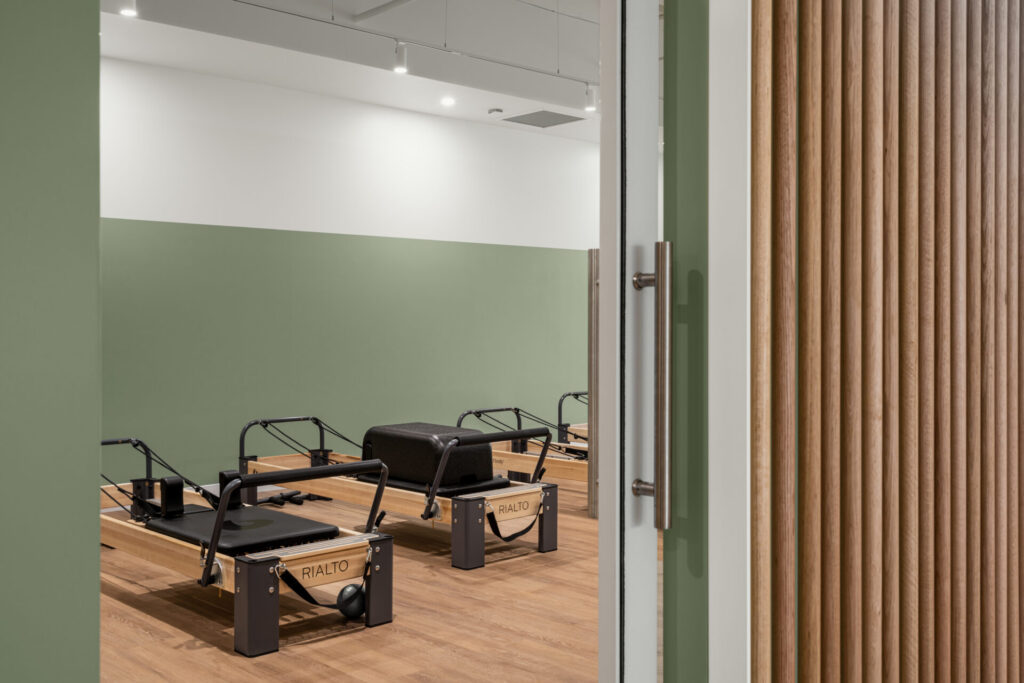 Pilates reformers, hardwood floors and welcoming reception area for this fitness fit out for Premium Pilates