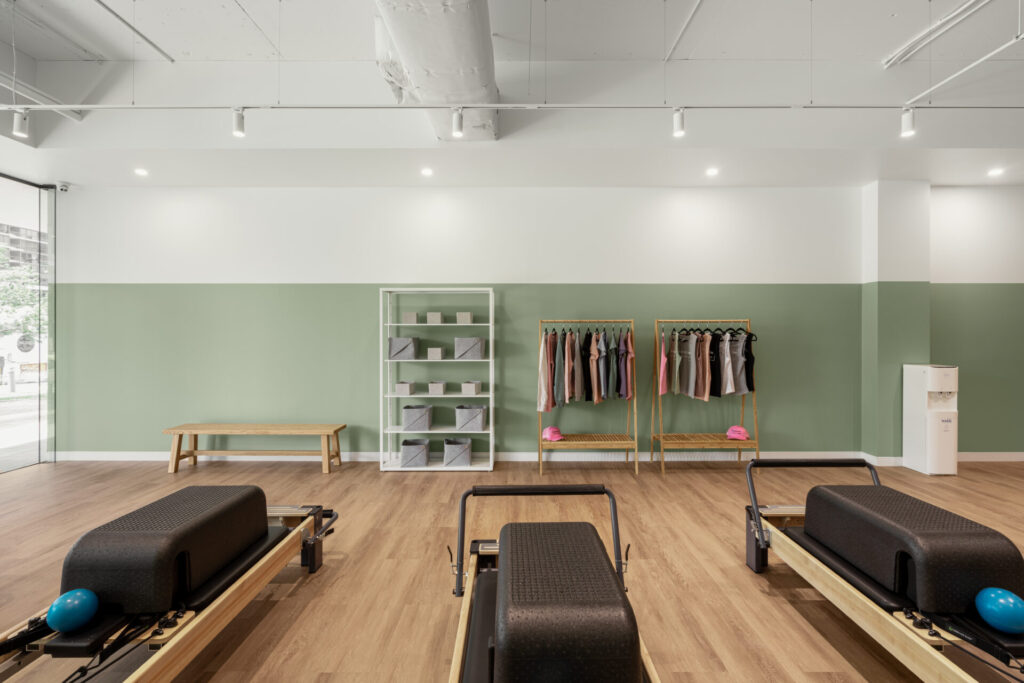 Pilates reformers, hardwood floors and welcoming reception area for this fitness fit out for Premium Pilates