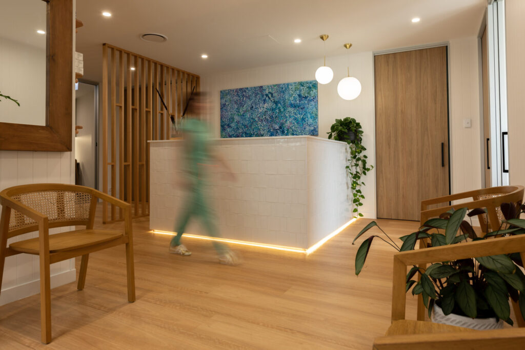 Warm coastal colour palette, bespoke timber panelling and welcoming reception area for this medical fit out for SunCoast Skin