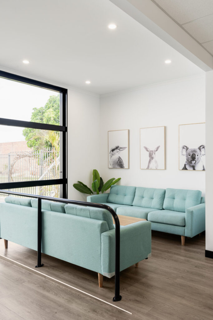 Blue and neutral colour palette, hardwood floors and welcoming reception area for this office fit out for Community Lifestyle Agency