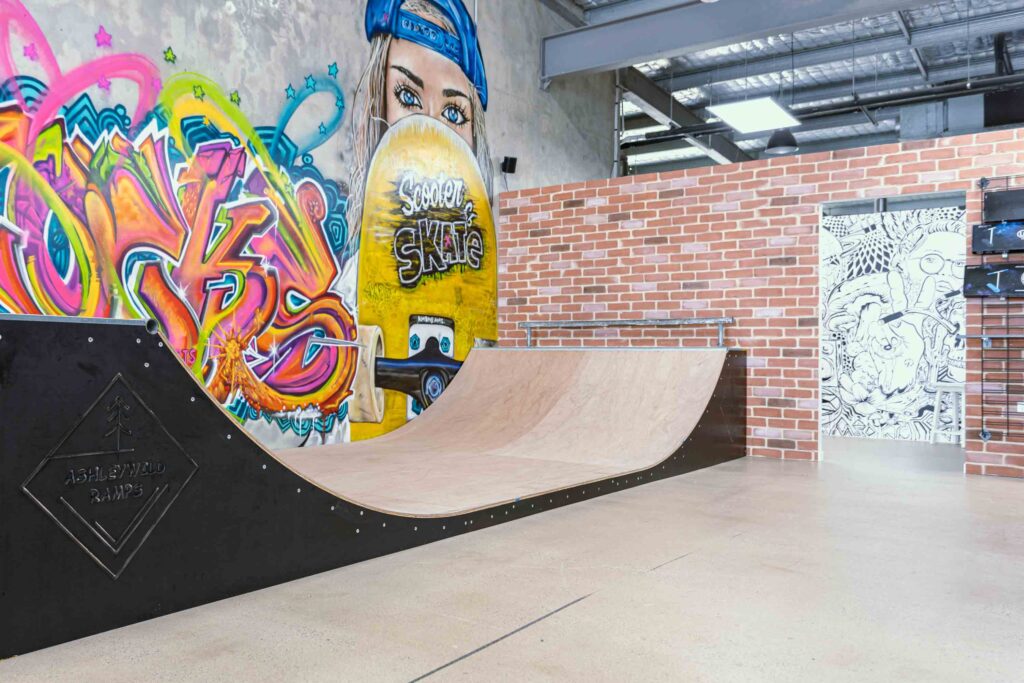 Durable concrete flooring, custom skate ramps and colourful spray paint wall designs for this retail fit out for Scooter and Skate