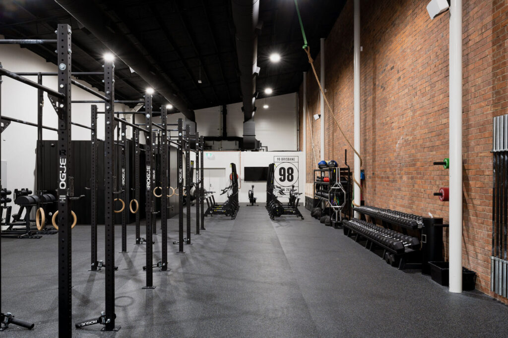 Custom brick wall, rubber flooring and high quality black equipment for this fitness fit out for 98 Gym