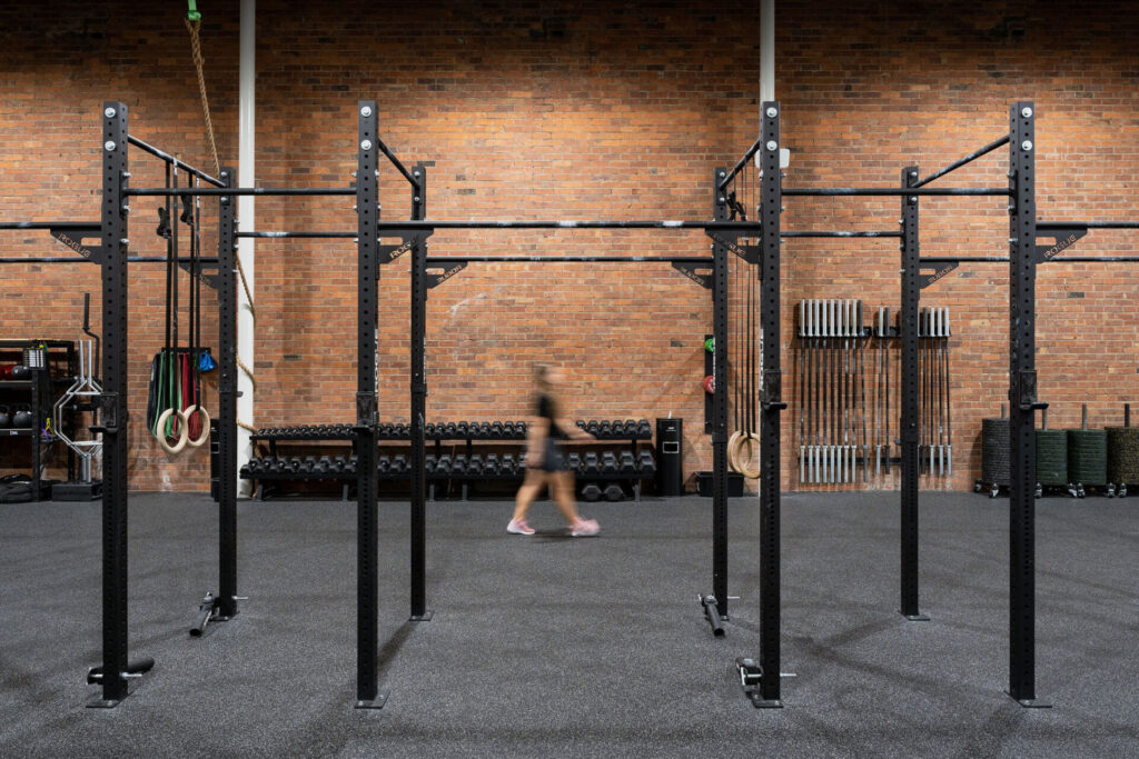 Custom brick wall, rubber flooring and high quality black equipment for this fitness fit out for 98 Gym