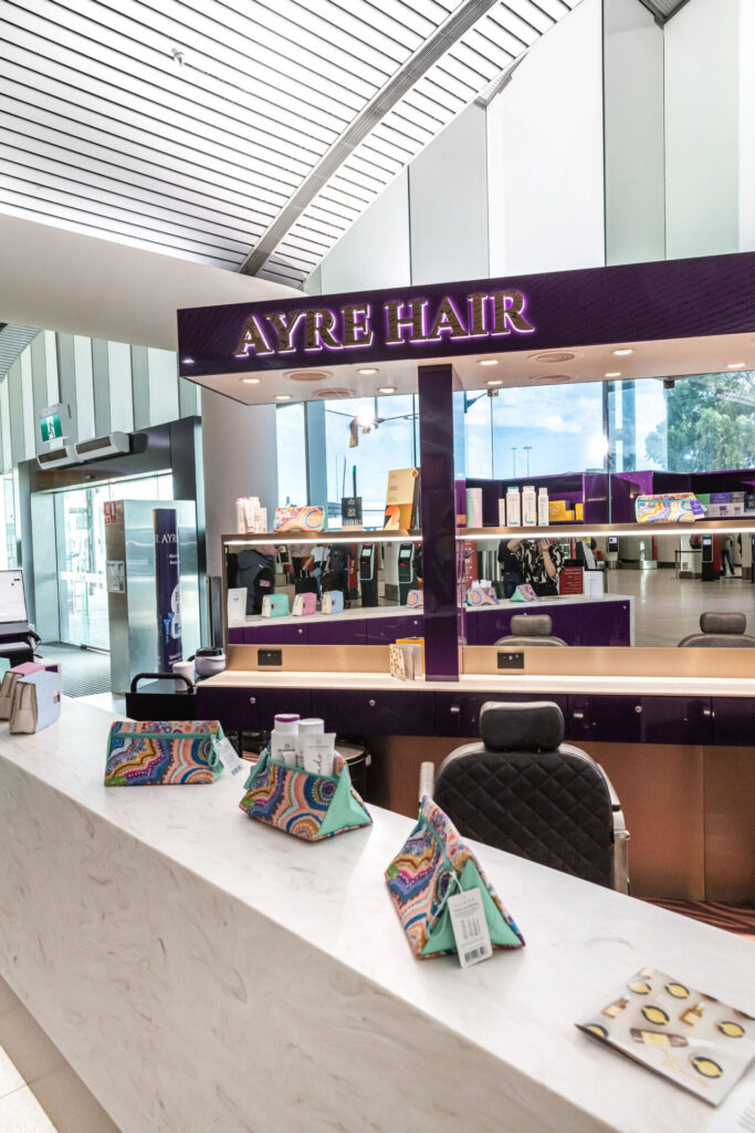 Purple and gold colour palette, custom LED signage and marble benchtops for this wellness & beauty fit out for Ayre Hair