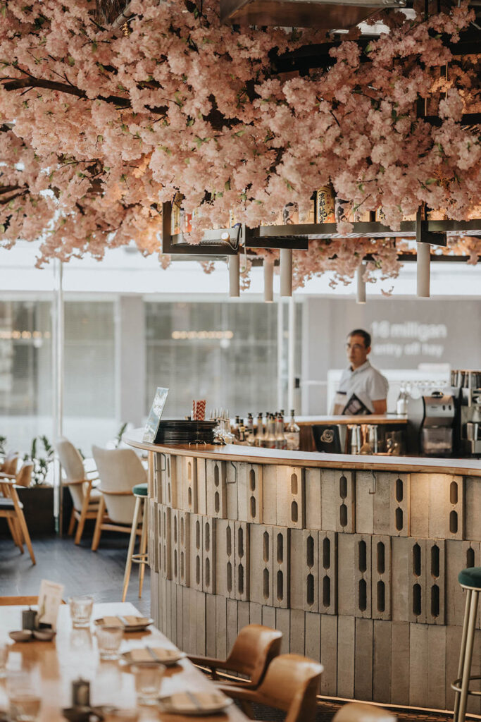 Custom Japanese cherry blossom tree, colourful Japanese modern decor and welcoming dining area for this hospitality fit out for Nippon