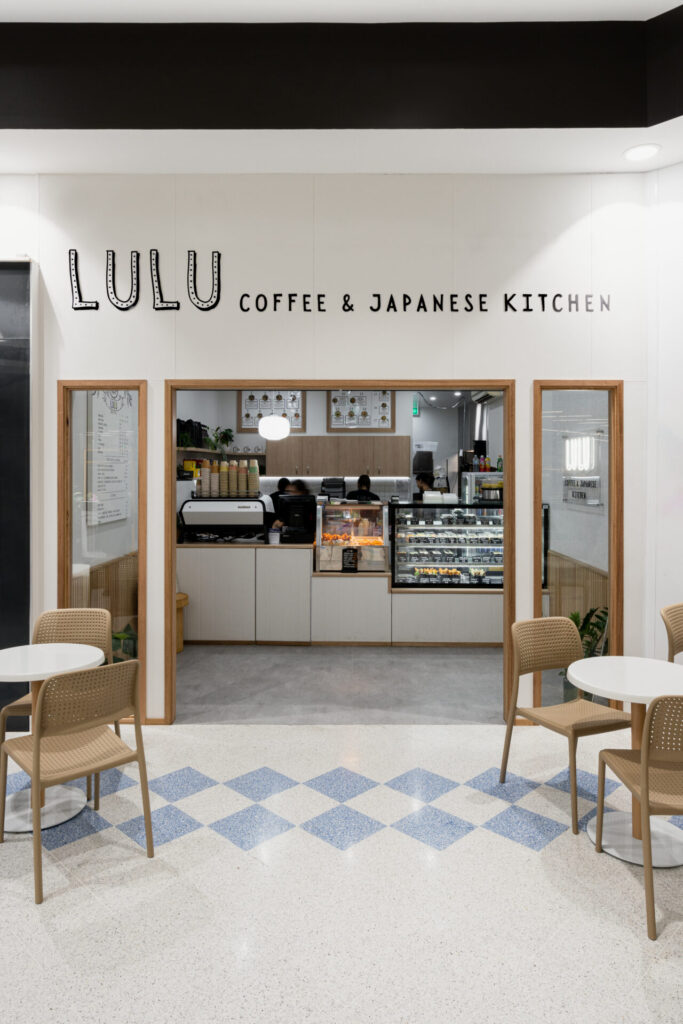 Wooden-incorporated and neutral colour palette, concrete floors and welcoming dining area for this hospitality fit out for Lulus Coffee & Japanese Kitchen