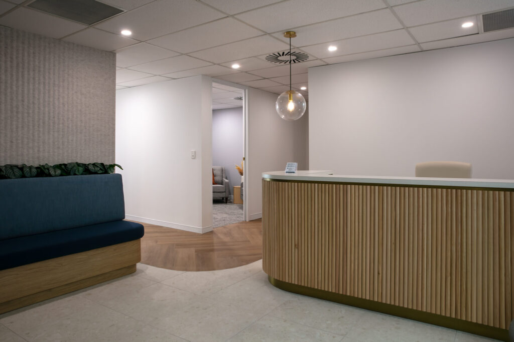 Neutral colour palette, vj reception panelling and welcoming reception area for this medical fit out for Mind Health Solutions