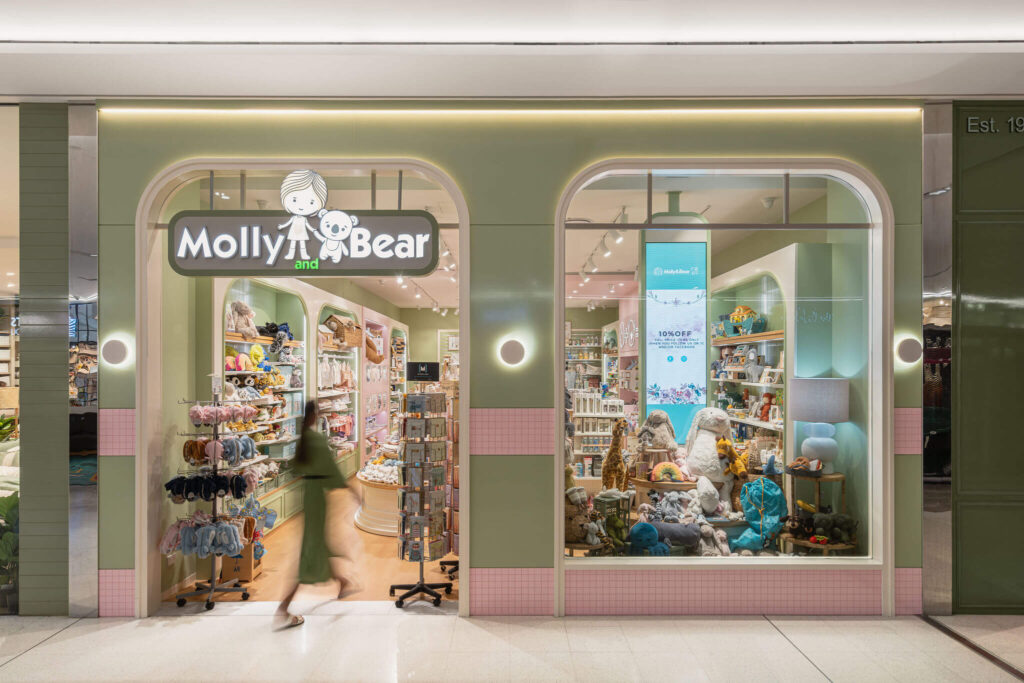 Bespoke merchandise displays, sage and pink colour palette and circular wall lights for this retail fit out for Molly and Bear