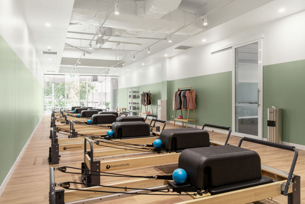 Pilates reformers, hardwood floors and welcoming reception area for this fitness fit out for Premium Pilates