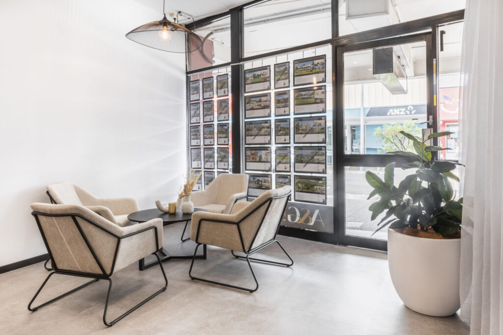 Neutral colour palette, hanging pendant lighting and welcoming reception area for this office fit out for A & G Realty