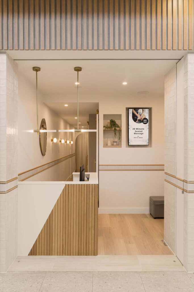Gold hardware pendant lights, hardwood floors and welcoming reception area for this wellness & beauty fit out for Square Massage Noosa, Total Fitouts Sunshine Coast South