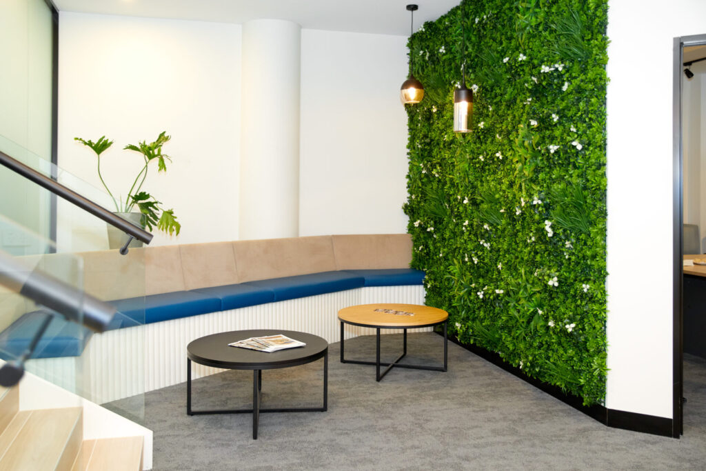 Custom plant feature wall, neutral colour palette and welcoming reception area for this office fit out for Canberra North Total Fitouts Design Studio