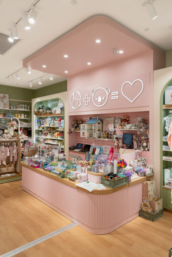 Sage and pink colour palette, hardwood floors and custom joinery merchandise displays for this retail fit out for Molly & Bear
