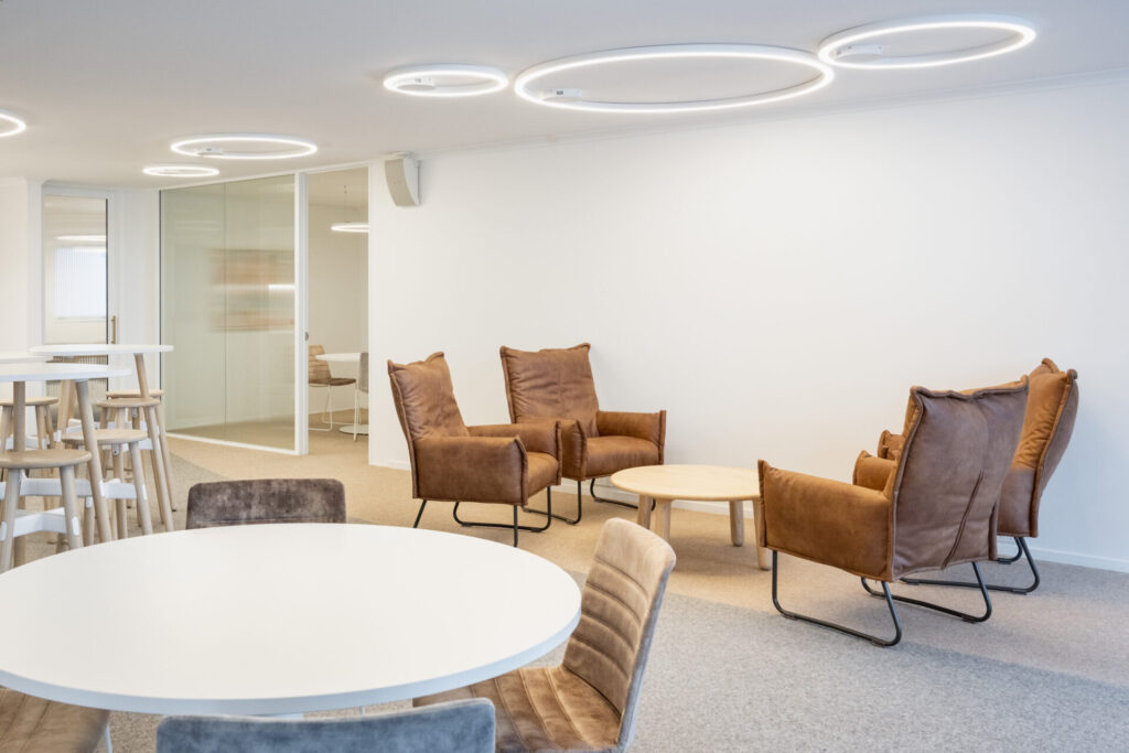 Neutral colour palette, hanging circular pendant lights and carpet flooring for this office fit out for Ray White