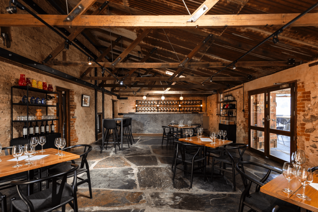 Timber features, brick and concrete textured walls and  wine rack and bar area for this hospitality fit out for Shingleback