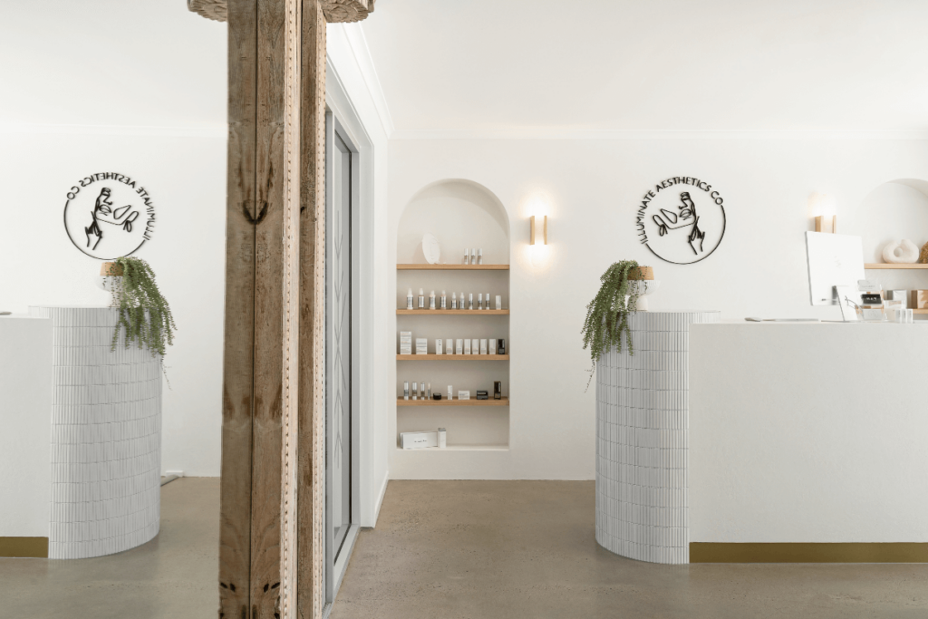 White subway tiling, bespoke signage and concrete flooring for this wellness and beauty fit out for Illuminate Aesthetics