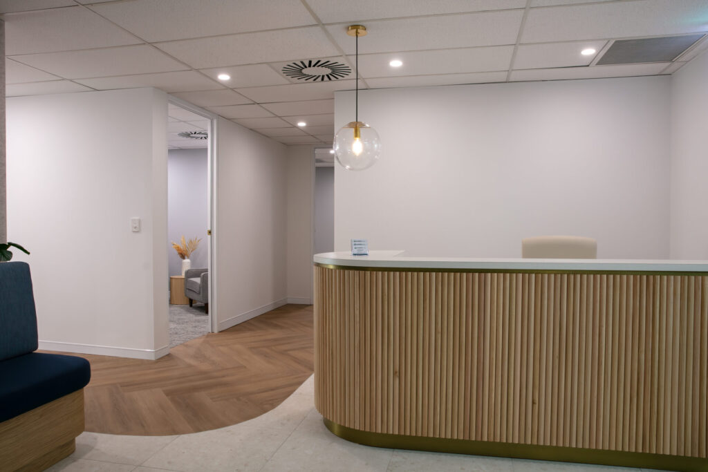 Timber vj panelling, hardwood herringbone floors and welcoming reception area for this medical fit out for Mind Health Solutions