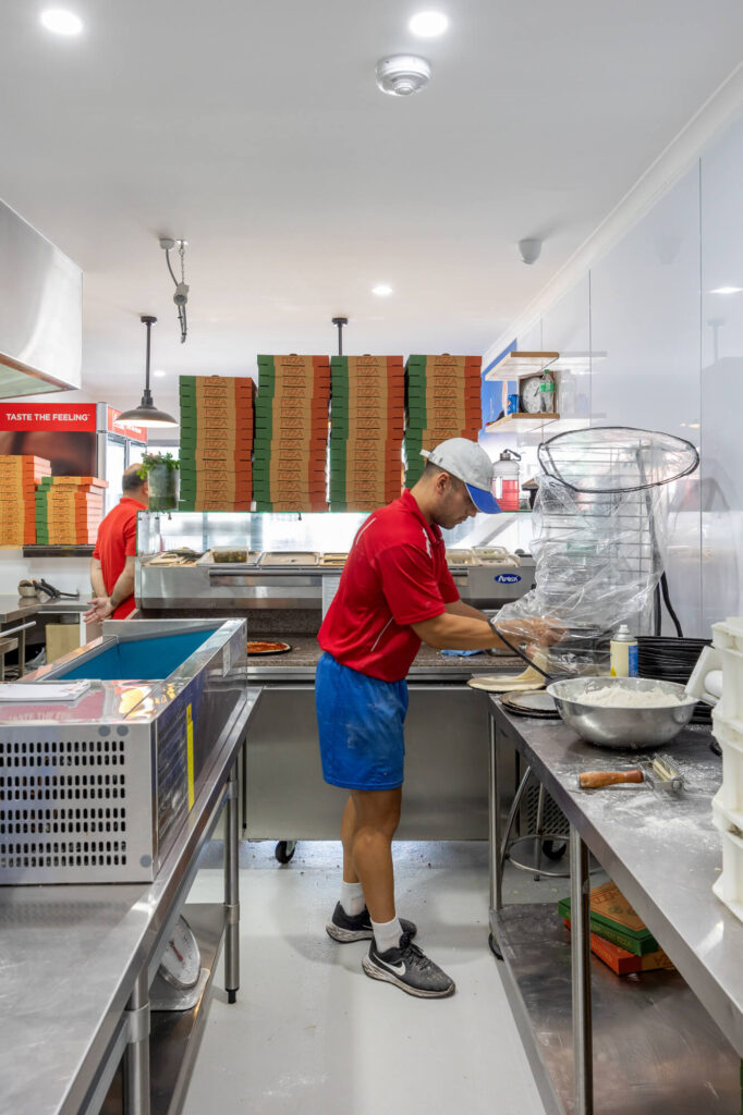 Large custom vinyl print wall, effective kitchen elements and eye-catching street appeal for this hospitality fit out for Giovanni's Pizza Bar, Total Fitouts Wide Bay