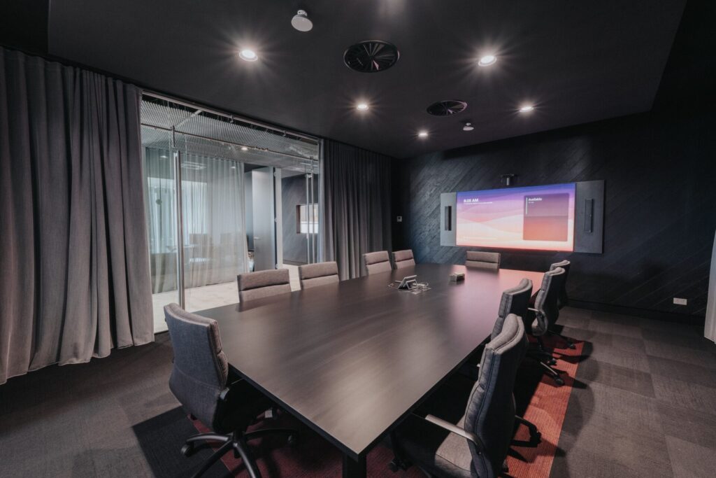 Mesh barrier ceilings, bold black and orange colour palette and striking reception area for this office fit out for Raubex, Total Fitouts Perth South