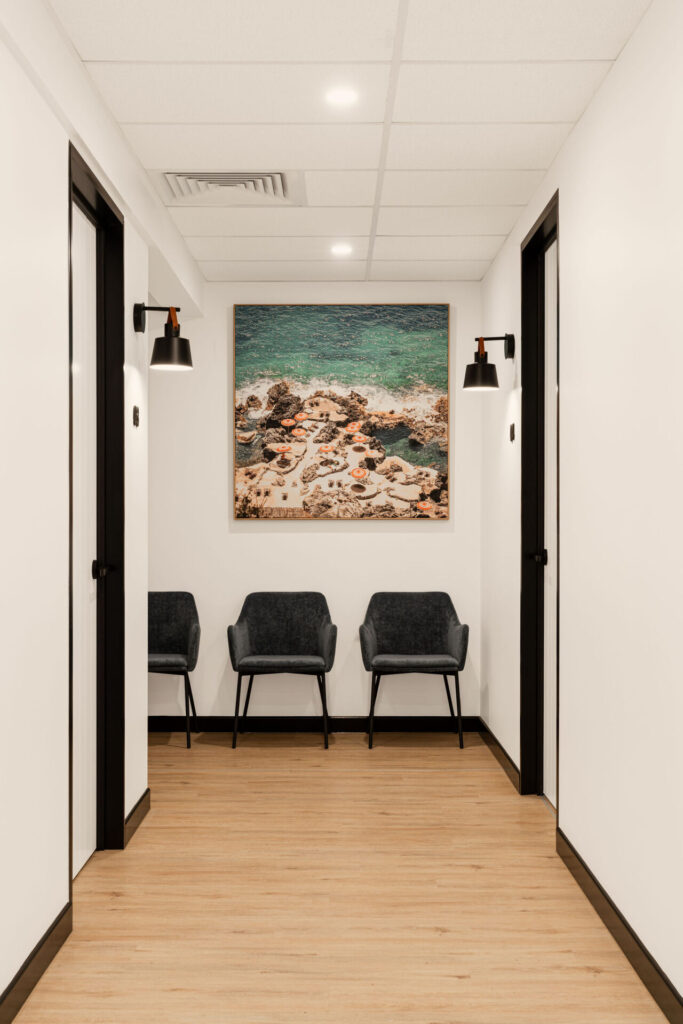 Black and white optometry equipment, a coastal-inspired aesthetic and sleek black wall lights for this medical fit out for Insight Eye Surgery, Total Fitouts Sunshine Coast South